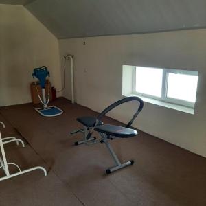 an empty room with a chair and a window at NR Rest House in Tsaghkadzor