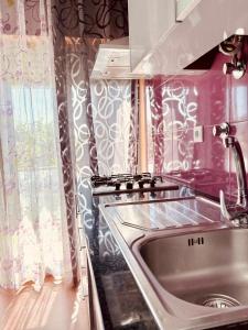 a kitchen with a sink and a window at Casa da Pontelha VILLA INN in Ponte de Lima
