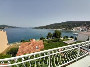 a view of a body of water from a balcony at Apartmani Mare Palada in Marina