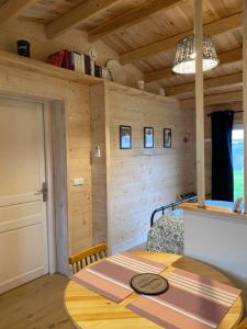 a bedroom with a bed in a room with wooden walls at Le colibri des prés in Maurens