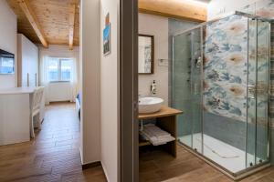 a bathroom with a glass shower and a sink at Cilento Sea Rooms in Agropoli
