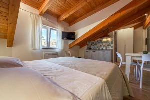 a bedroom with a large white bed and a table at Cilento Sea Rooms in Agropoli