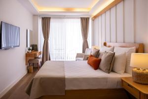 a bedroom with a large bed and a window at Skopea Inn Exclusive Hotel in Göcek