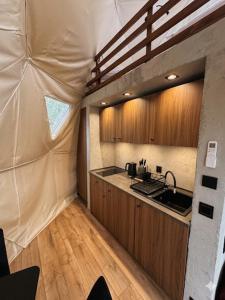 a kitchen in a tent with a sink and a counter at Glamping LA BELLA Suntago in Aleksandria