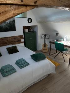 a bedroom with a bed with a green dresser and a table at Villa Ô bedroom 1 in Chasnay