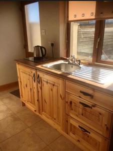 a kitchen with a sink and a window at Kathleen’s Haven in Causeway