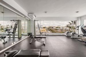 a gym with cardio equipment and a large window at Lincoln Suite in Santo Domingo