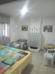 a bedroom with two beds and a fireplace in it at Hydrovor Apartment & Room in Hamallë