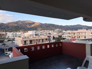 a view of a city from the balcony of a building at ERODIOS apartments in Karistos
