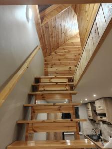 a staircase in a house with wooden ceilings at Zakątek Sądrecko in Rząśnik