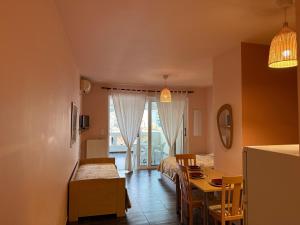 a room with a bed and a table and a dining room at ERODIOS apartments in Karistos