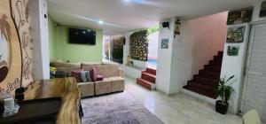a living room with a couch and a staircase at hostel Santamaria in Rodadero