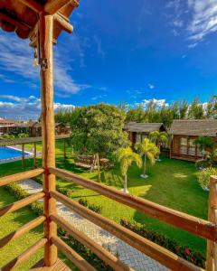a view of a yard from a wooden fence at Pousada La Belle de Jour in Majorlândia