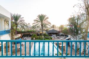 a view from the balcony of a resort with a pool at Appart Hotel Rodes in Mezraya