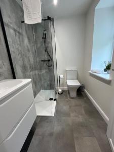 a bathroom with a shower and a toilet at Craig Cottage in Banff +29 photos