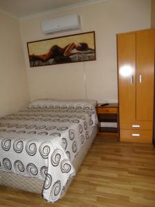 a small bedroom with a bed and a dresser at hotel rancagua in Rancagua +7 photos