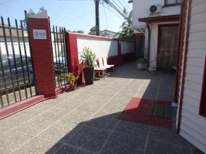 a patio with a fence and some chairs at hotel rancagua in Rancagua