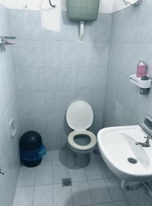 a bathroom with a toilet and a sink at Habitación 4 in Asunción +12 photos