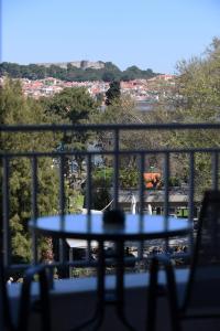 a table on a balcony with a view of a city at The ViewPoint VP2 - Το διαμάντι της θέας in Mytilene +27 photos