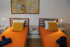 two beds sitting next to each other in a room at Ocean front surf House El Cotillo in El Cotillo