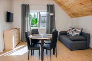 a living room with a table and a couch at Apartamenty Suchacz in Suchacz