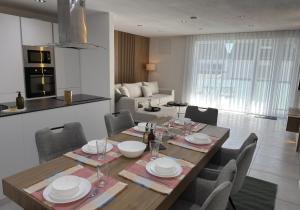 a dining room and kitchen with a table and chairs at JAM Suite in Koblenz