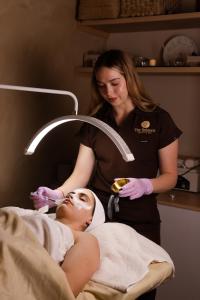 a woman in a hospital bed with a woman doing a massage at Hotel Refugio in San Juan de los Lagos