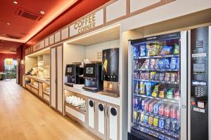 a store aisle with a soda vending machine and drinks at B&B HOTEL Miranda de Ebro in Rivabellosa
