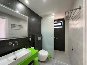 a bathroom with a sink and a toilet and a mirror at Bouradanis Art Hotel in Marmari +46 photos