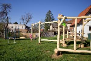 a playground in a yard with a swing set at Chata Prandorf in Devičany