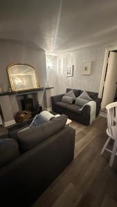 a living room with a couch and a mirror at No 4 Devon Square in Kingsbridge