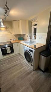 a kitchen with a washing machine in the middle at No 4 Devon Square in Kingsbridge +17 photos