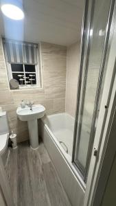 a bathroom with a tub and a sink and a shower at No 4 Devon Square in Kingsbridge