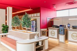 a store with pink walls and a counter with plants at B&B HOTEL Miranda de Ebro in Rivabellosa +38 photos
