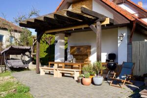 a patio with a wooden pergola and a wooden bench at Chata Prandorf in Devičany