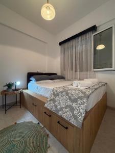 a bedroom with a bed with a sink and a window at Stegna Sunny-Beach in Archangelos