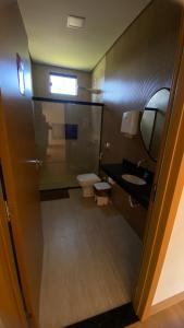 a bathroom with a toilet and a sink and a mirror at Recanto das Palmeiras hidro in Hidrolândia +18 photos