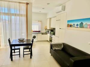 a living room with a couch and a table at Trajadinha in Vila Praia de Âncora