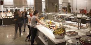 a group of people standing in a kitchen preparing food at Parkside Student Residence Downtown Toronto in Toronto