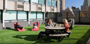 a group of people sitting around a table in the grass at Parkside Student Residence Downtown Toronto in Toronto
