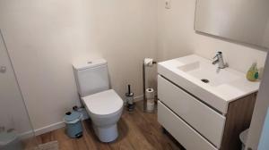 a bathroom with a white toilet and a sink at Principality Apartment in Cardiff