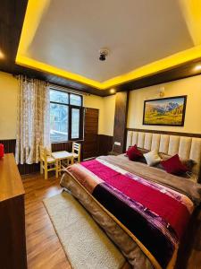 a bedroom with a large bed and a window at Sati Heights in Vashisht