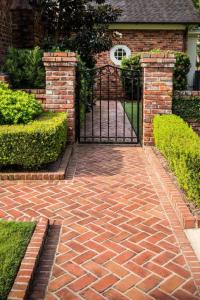 a brick driveway with a gate in front of a house at Coco Villa Payagala in Paiyagala South