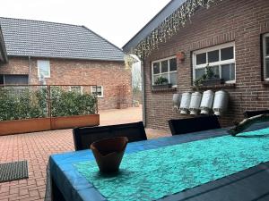 a table with a blue table cloth on a patio at De Moolt Vakantiewoningen in Eckelrade
