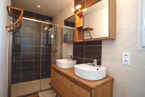a bathroom with a sink and a mirror and a shower at La Parenthèse d'Hasparren - Avec Parking Privé in Hasparren