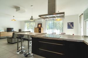 a kitchen with a large island in the middle at La Parenthèse d'Hasparren - Avec Parking Privé in Hasparren +5 photos