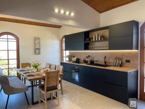 a kitchen with a table and a dining room at Villa Punta in Maslinica