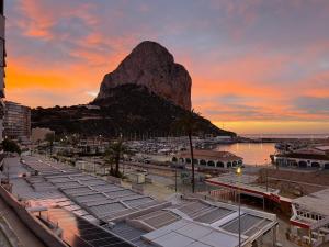 a view of a mountain with a marina at sunset at Ti Miquel in Ifach