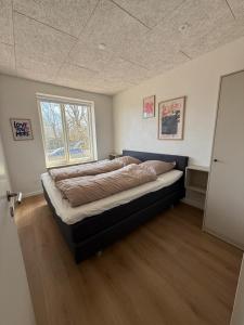a bedroom with a large bed in a room at Completely renovated apartment, 6 sleeps in Herning