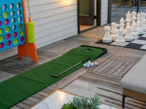 a miniature golf course with a giant chessboard and a putting green at Sleeps 8 - Rooftop Deck - Prime Location in Raleigh